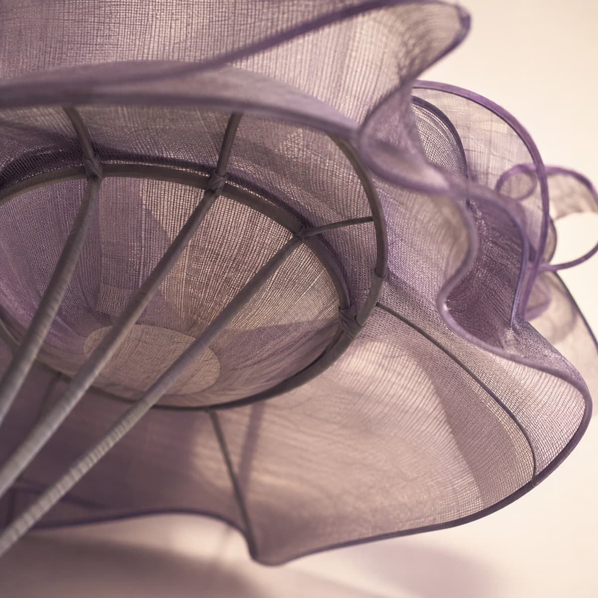 Macro photograph of a covered wire armature and buckram base inside a hat