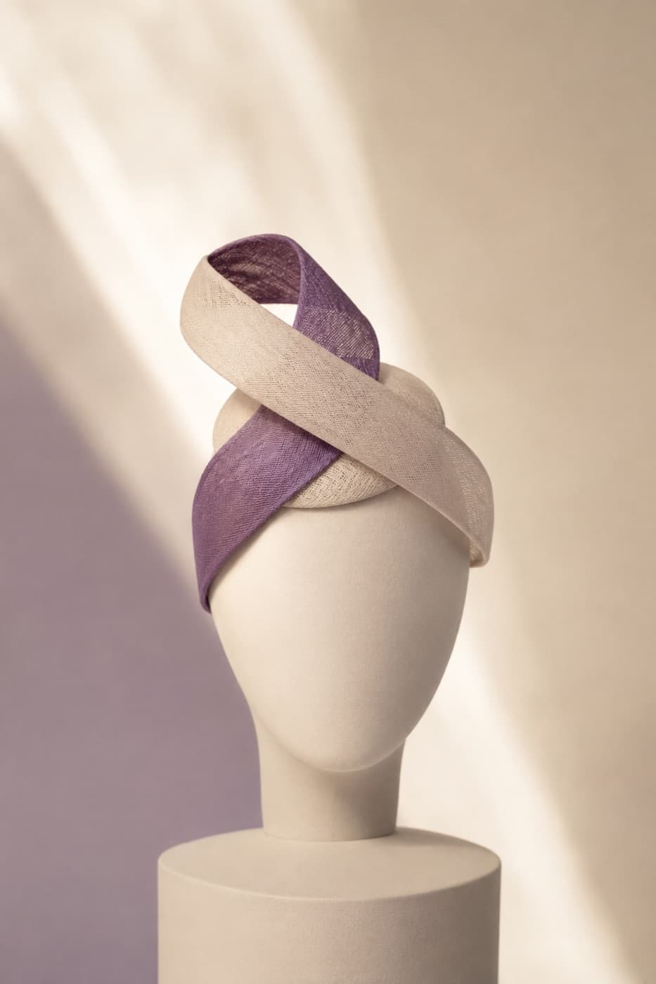 Fascinator Twist photographed whole against an ivory ground
